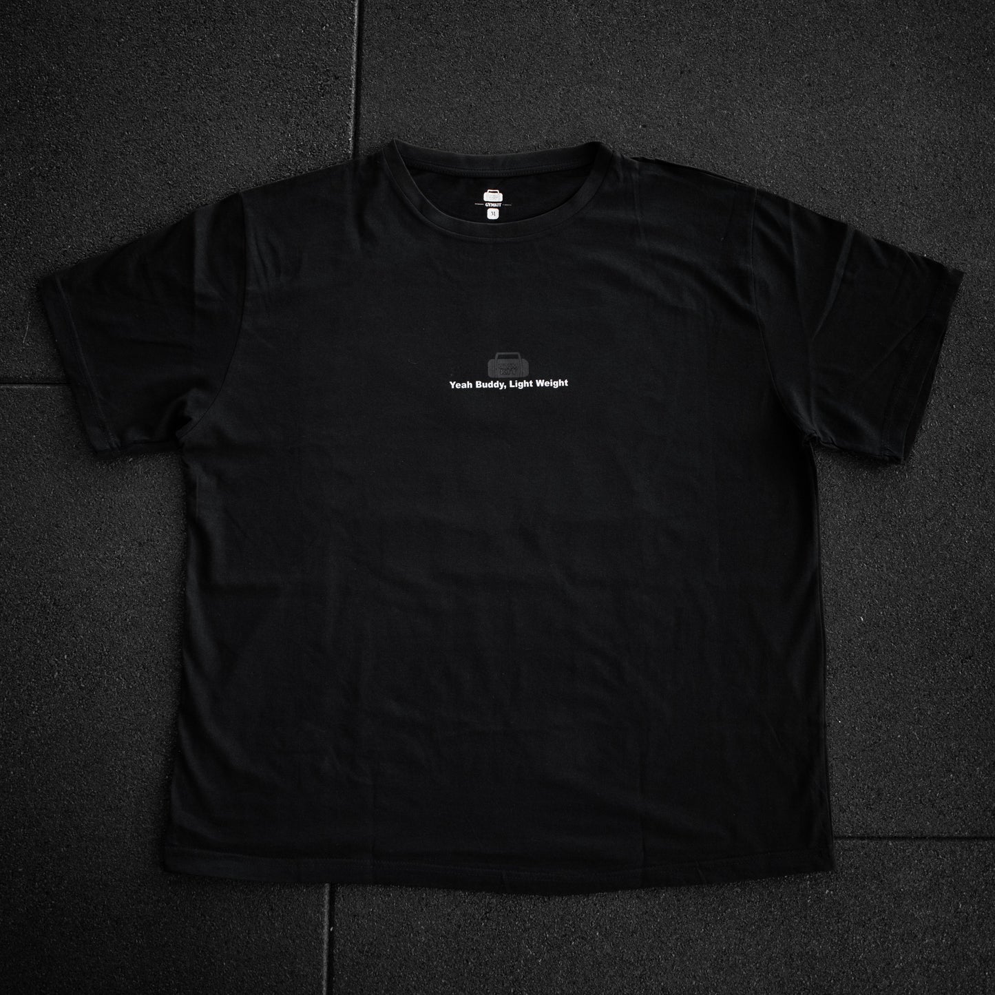 Black t-shirt with a small white logo on a dark background