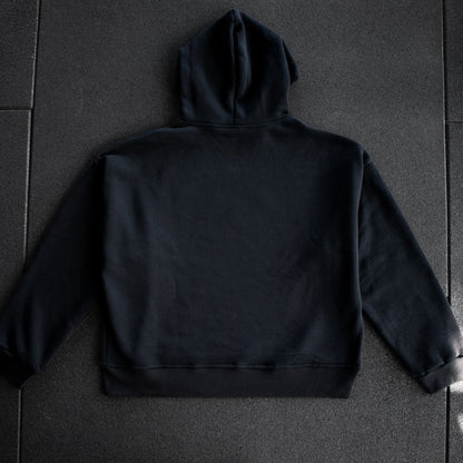 Black hoodie on a dark textured surface