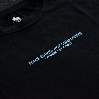 Black t-shirt with white text 'MAKE GAINS, NOT COMPLAINTS' on a dark background